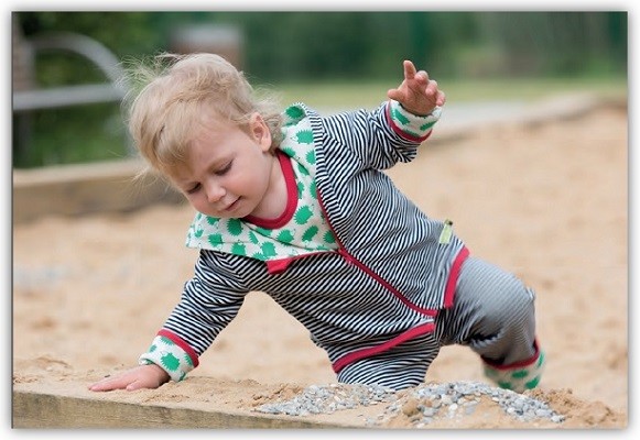 Kind beim Spielen im Sandkasten in loud and proud Kleidung