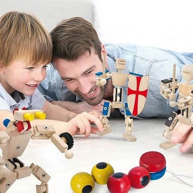 Vater und Sohn spielen mit Action-Figuren aus Holz